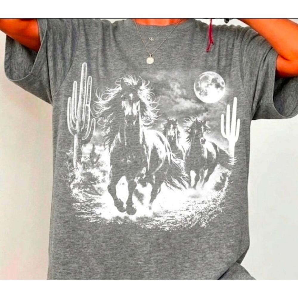 Horses riding through the desert